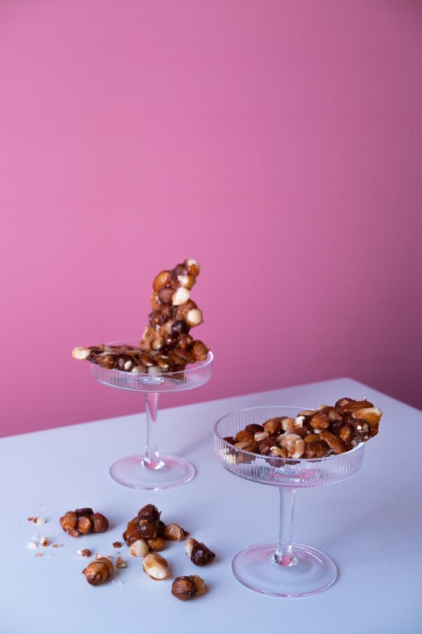 Peanut Brittle | Sugar free nut brittle with pink background in glass container | No lighting