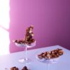 Peanut Brittle | Sugar free nut brittle with pink background in glass container