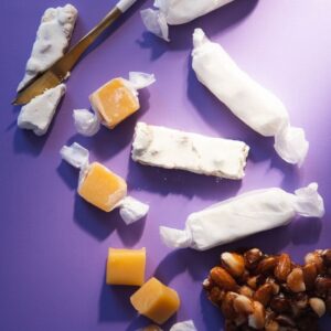 Sugar free nougat, salted caramel, and nut brittle with purple background