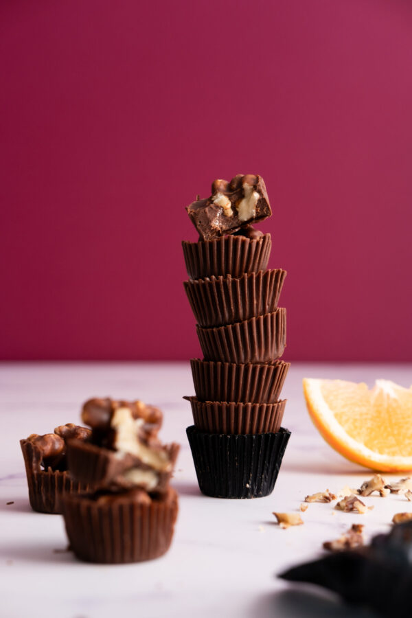 Sugar-free orange and walnut bites with dark pink background