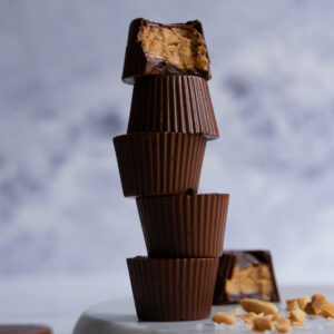 dark chocolate peanut butter cup in light grey background