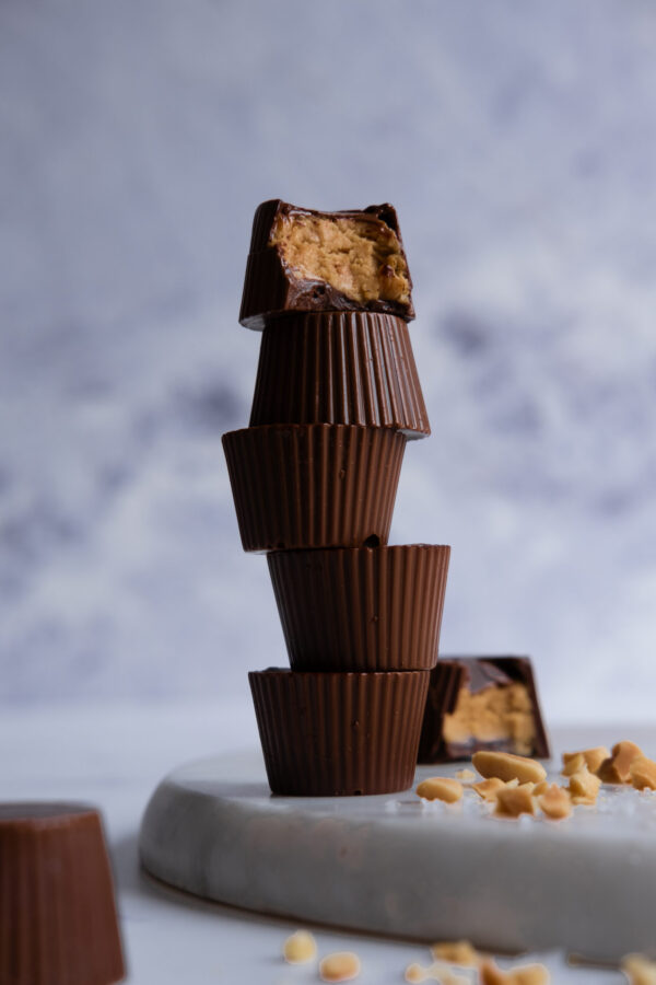 dark chocolate peanut butter cup in light grey background